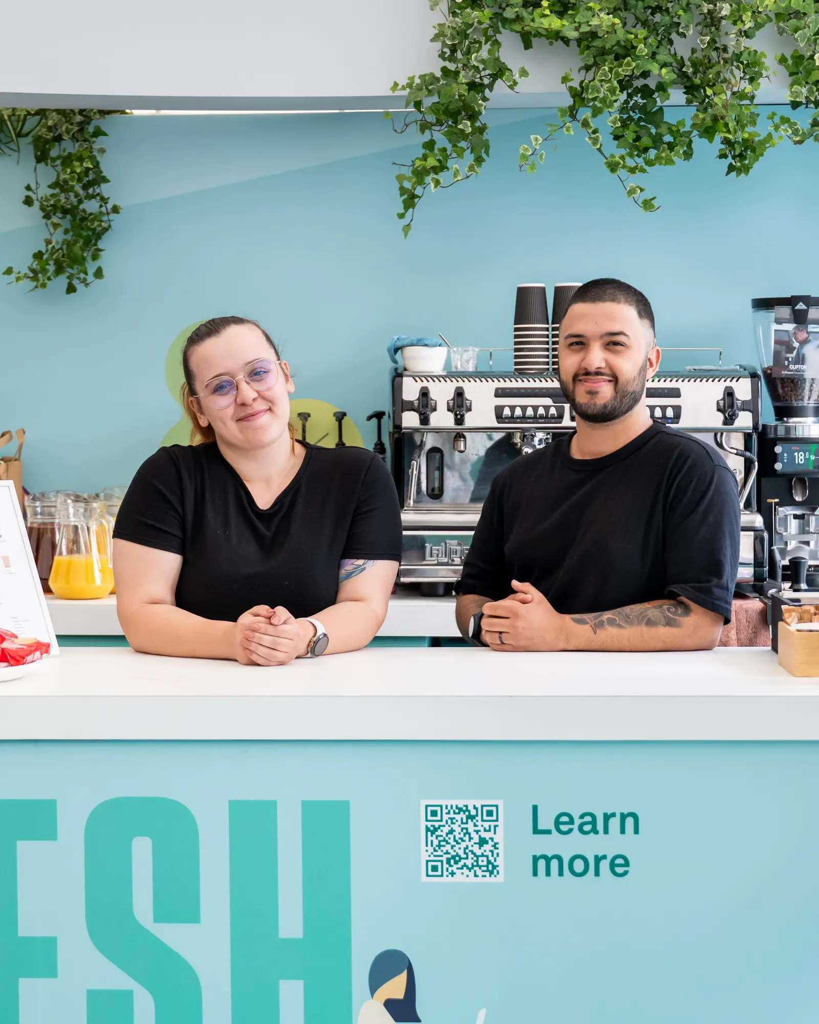 Vitor and Vanessa, Here Coffee founders, behind their coffee cart
